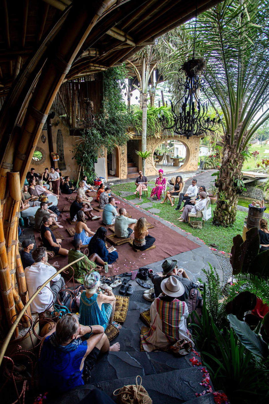Wide shot from under the bamboo structure, full crowd gathered