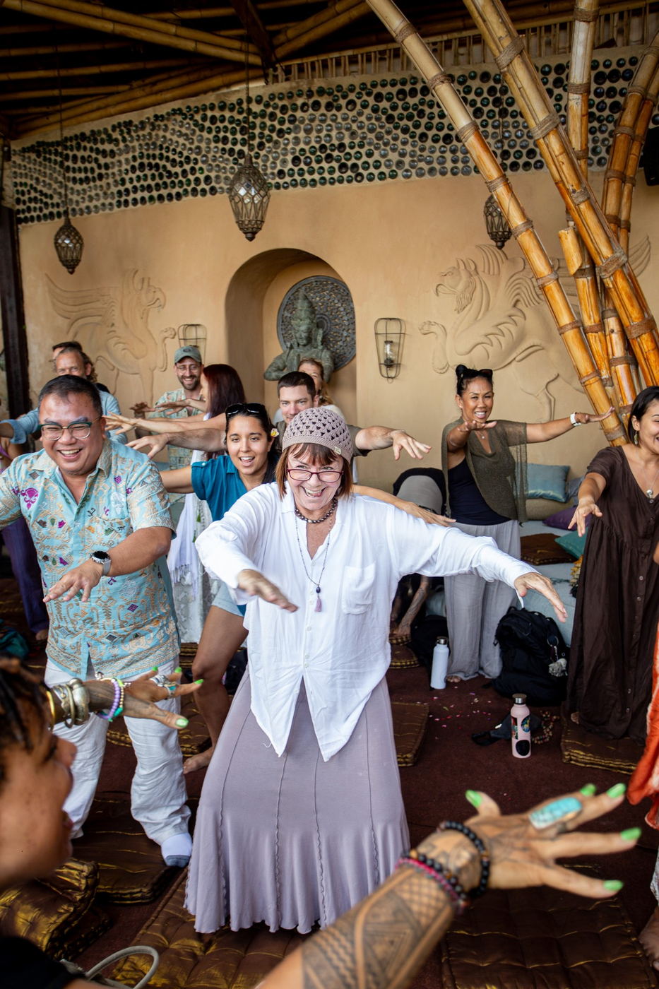 Group dancing together with arms spread