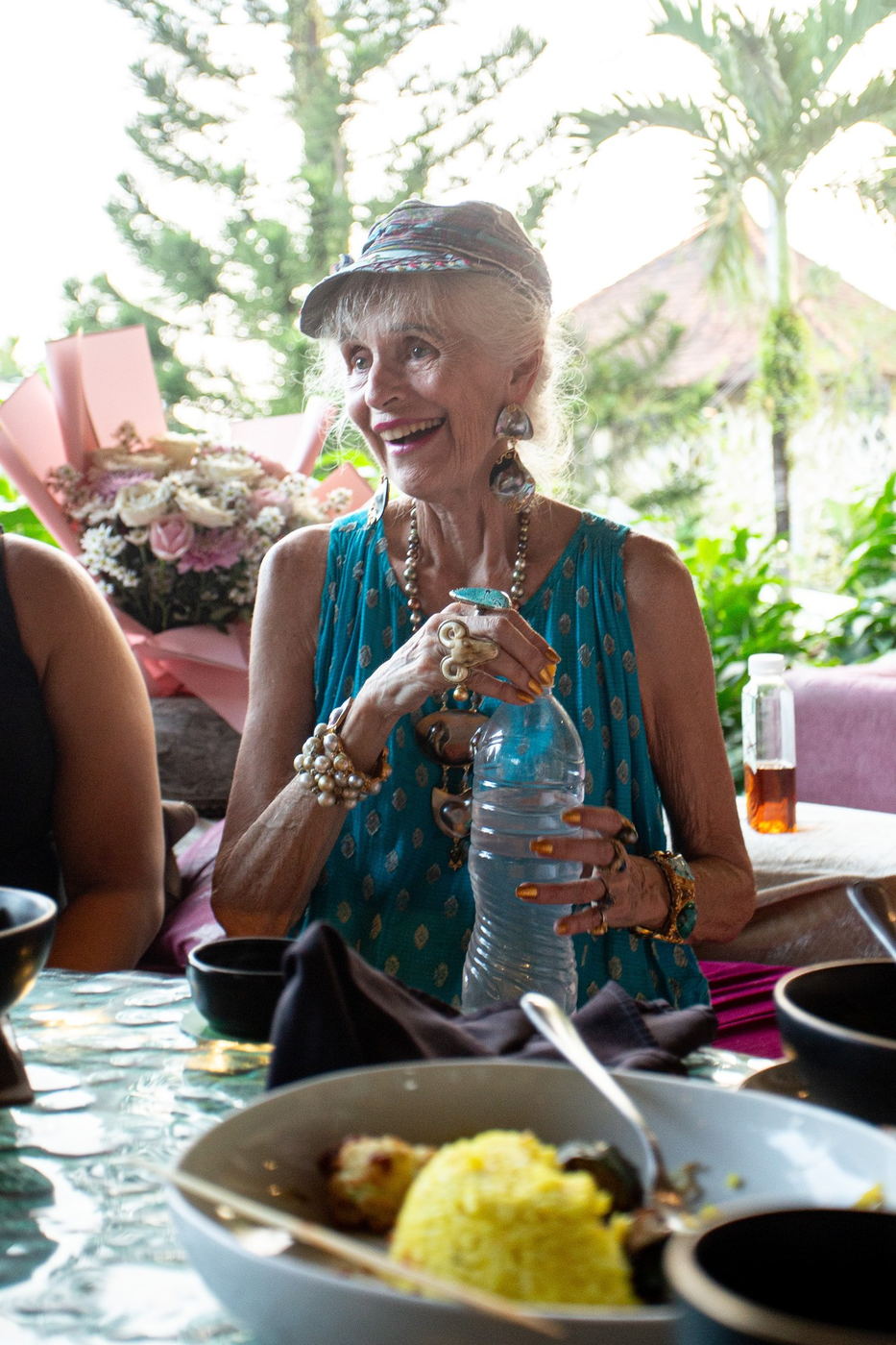 Older woman smiling with flowers