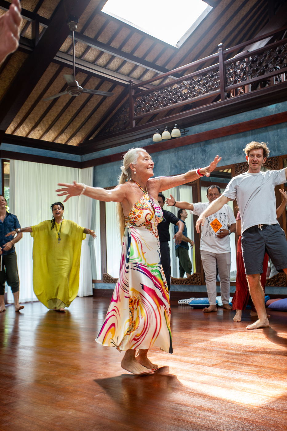 Participant with arms spread wide, mid-movement