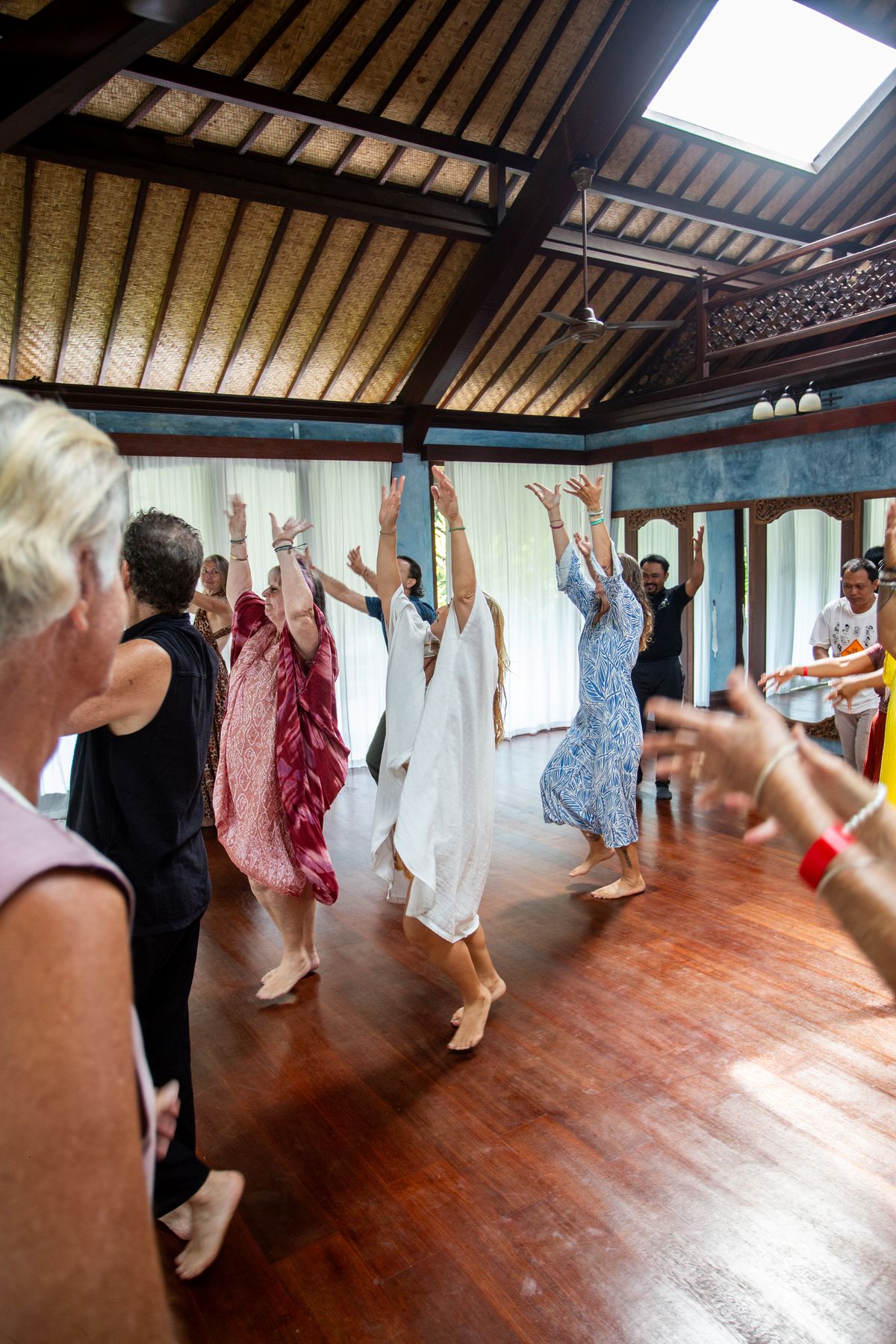 Group moving together with arms raised overhead