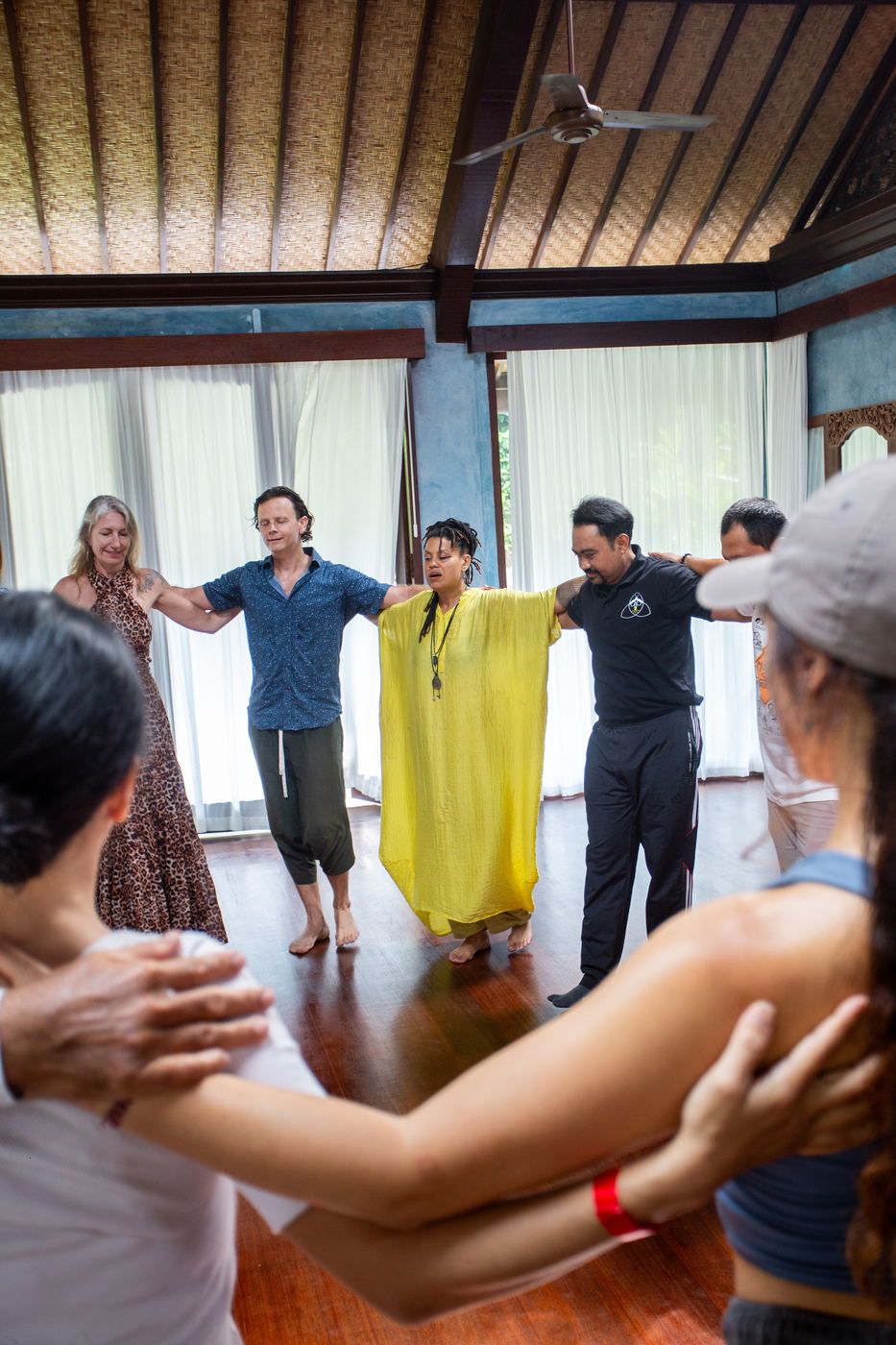 Participants in a circle with arms interlocked