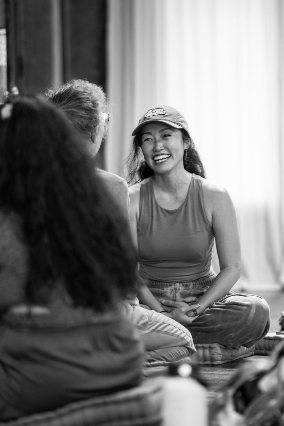 Two participants smiling in conversation, black and white