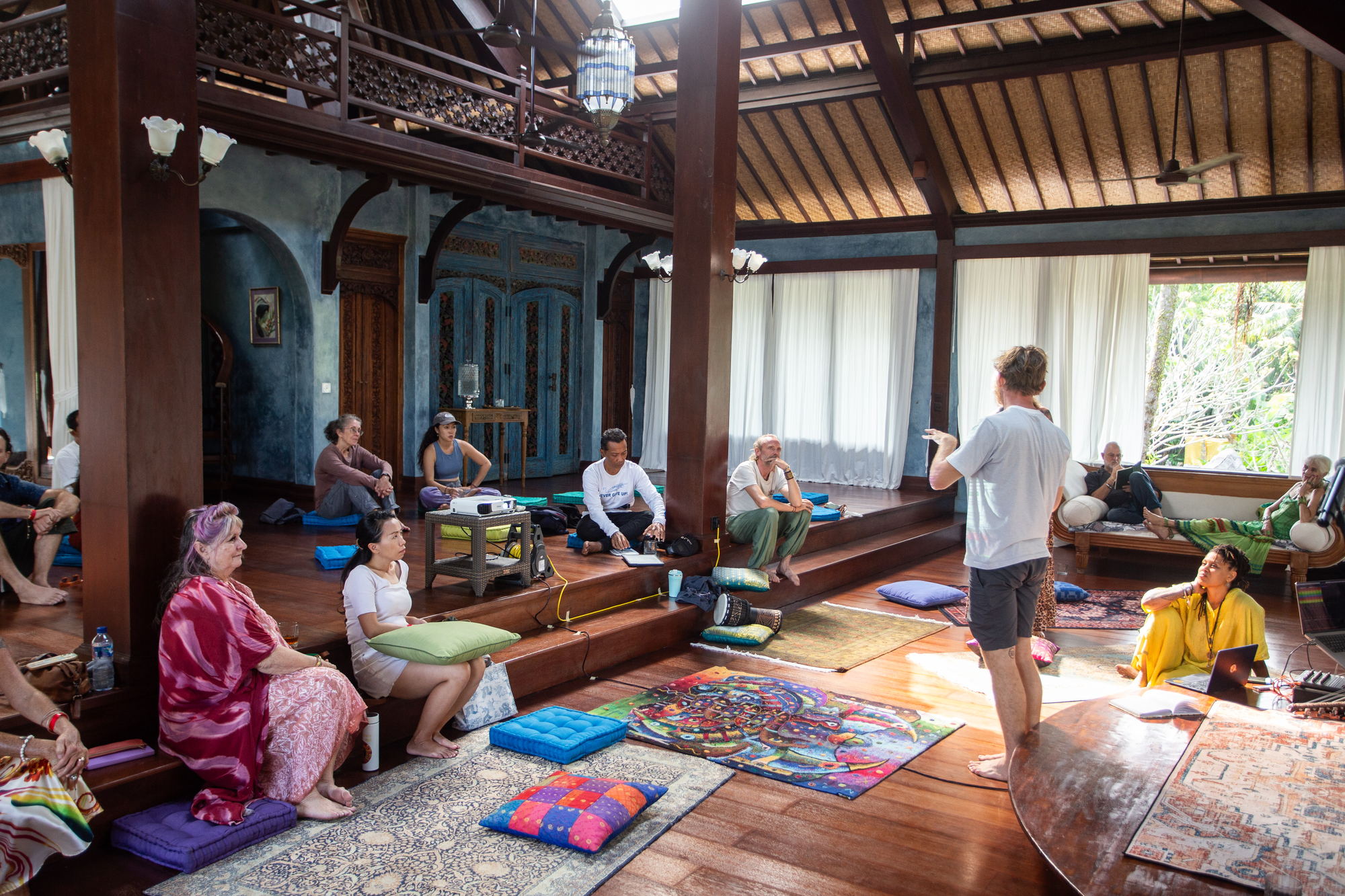 Wide view of the seated group in session