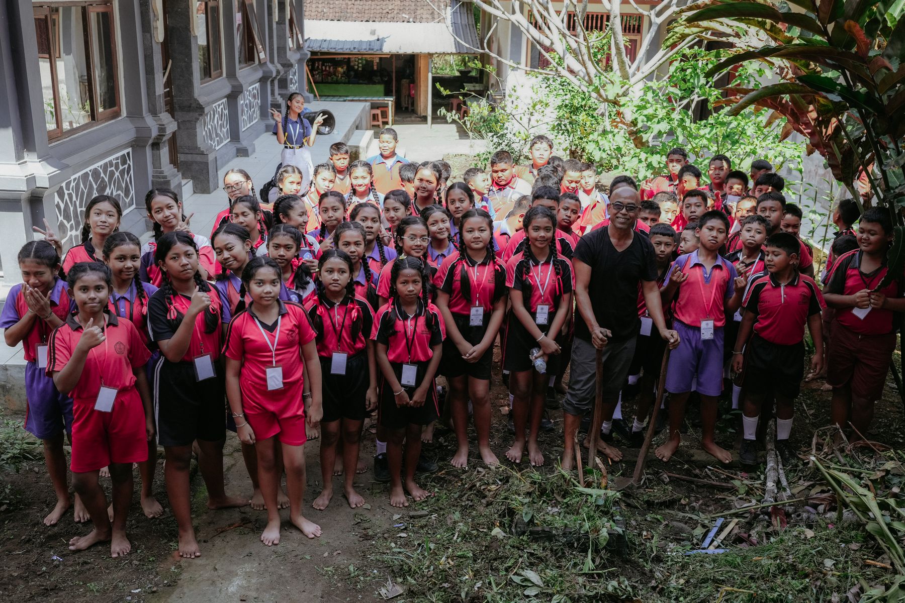 Students in school sports uniforms gathered in the courtyard