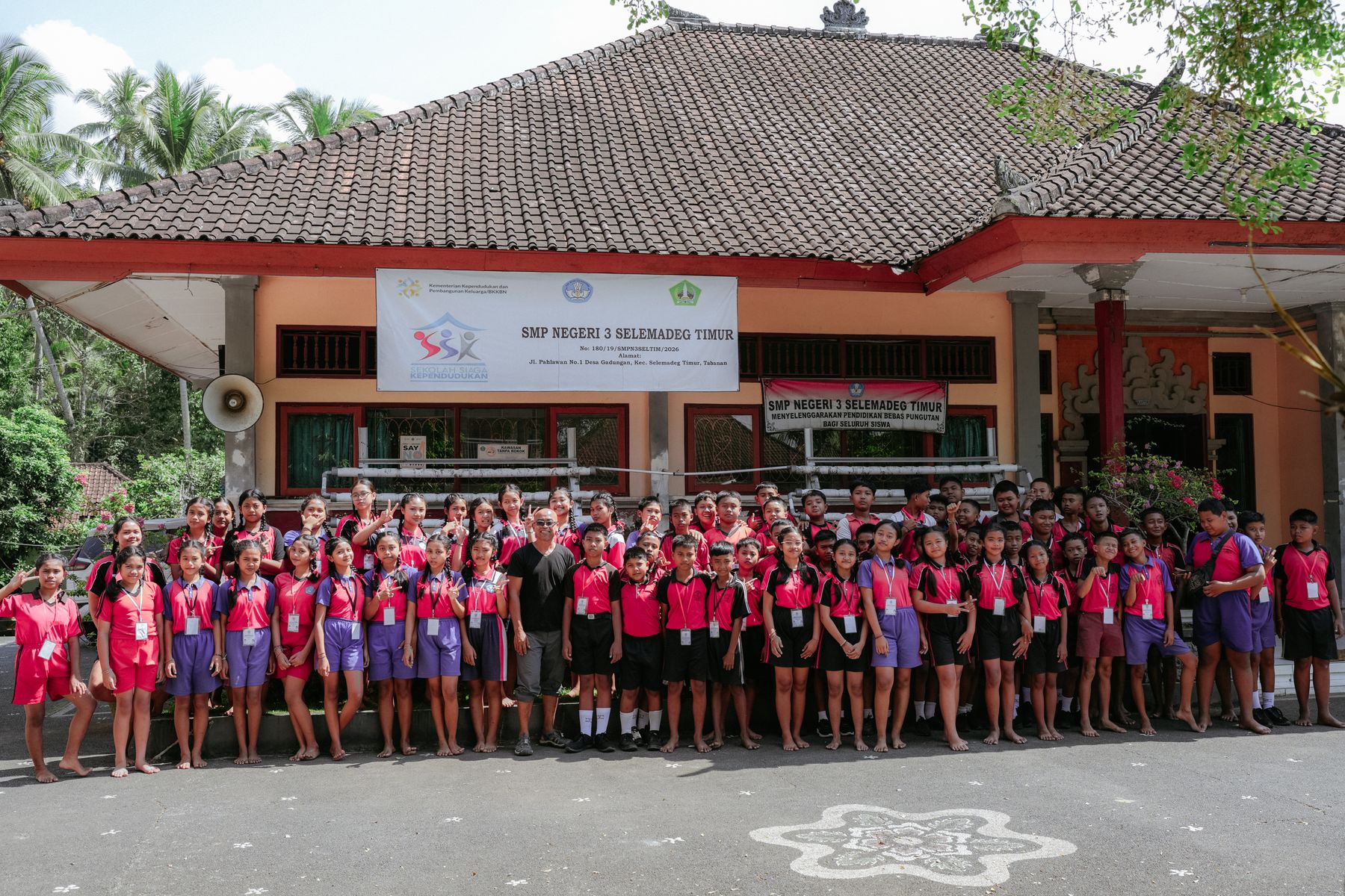 The school assembled beneath the SMP Negeri 3 Selemadeg Timur banner